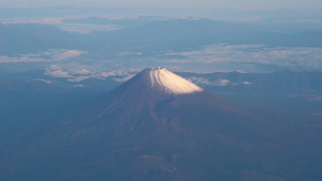 A bird's eye view close-up the Mount Fuji ( Mt. Fuji ) and blue sky. Scenery landscapes of the Fuji-Hakone-Izu National Park. Shizuoka Prefecture, Japan. 4K UHD