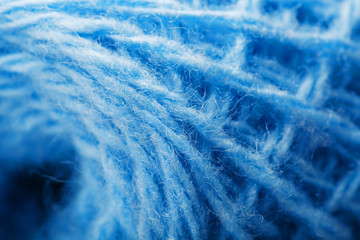 Wool yarn close-up colorful blue threads for needlework in macro.