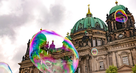 Berlin, Germany, Religion - The famous Berlin Cathedral and big rising soaps bubbles. © Copula