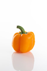 Fresh orange bell pepper on a white background