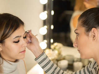 Beautician making lash lifting with brush