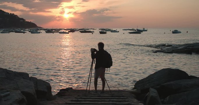 Photographer creates content with camera in sunset
