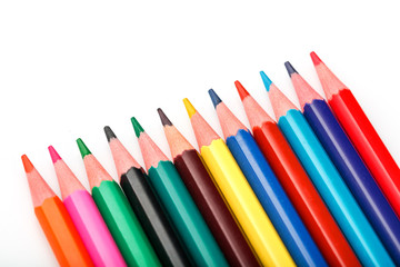 Colored pencils in a row on a white background, free space for text.