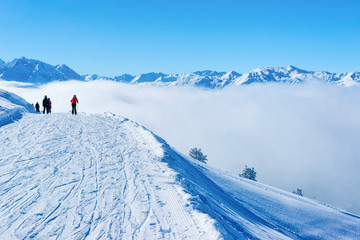 Skiers skiing in Zillertal Arena ski resort in clouds Austria