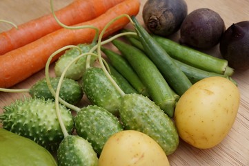 Vegetables and starches on white background. Carrots, okras, chayote, gherkin, sweet potato and beet.