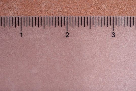 transparent ruler on neutral background with sharp lines showing numbers 1 2 3