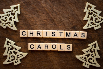 the words Christmas Carols on wood