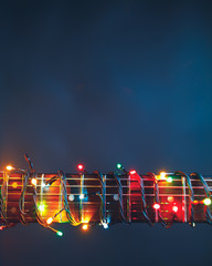guitar finger-board with multicolor lights, festive background