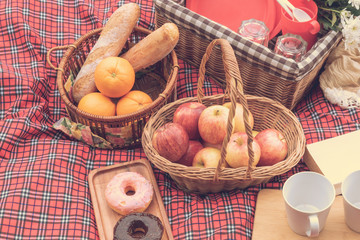 Obraz na płótnie Canvas Summer time.Closeup of picnic basket with food and fruit in nature.
