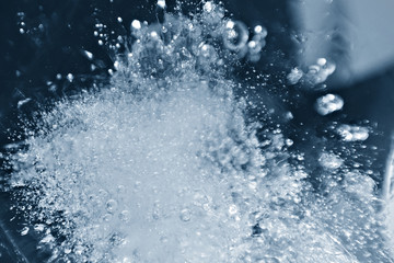 Blurred background of ice in a glass. Abstract Christmas background.