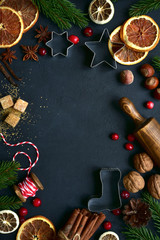 Christmas festive baking background with ingredients and props for making cake or biscuit. Top view with copy space.