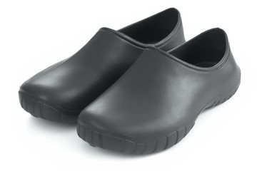 Dirt protection overshoes. Galoshes or rubbers. Traditional countryside protection for shoes. Black rubber footwear.