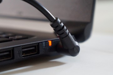Plug adapter connected to laptop computer.