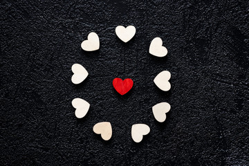 Wooden hearts on a black background. Valentines Day concept.