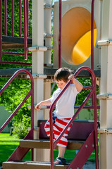 A Little boy enjoying his day at the city park