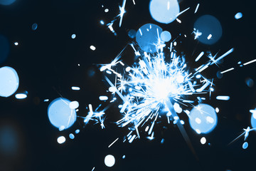 Sparklers on bokeh background. New Year, Christmas, holiday, Thanksgiving, birthday. Surprise,...