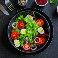 healthy salad vegetables, quail eggs (tomato, lettuce and other ingredients) menu concept. food background. top view. copy space