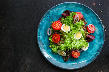 healthy salad vegetables, quail eggs (tomato, lettuce and other ingredients) menu concept. food background. top view. copy space