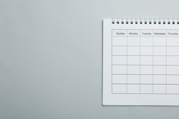 Blank calendar on light grey background, top view. Space for text