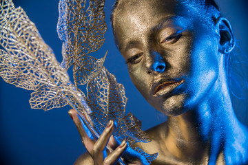 Close-up silver portrait of a woman with glitter make-up
