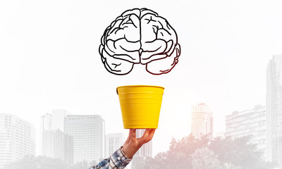 Brain drawing flying above yellow pot