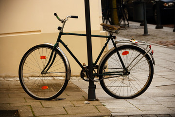 Fototapeta na wymiar Old bicycle parked on old town sidewalk