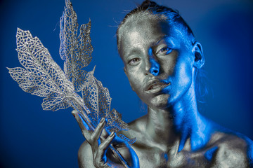 Close-up silver portrait of a woman with glitter make-up
