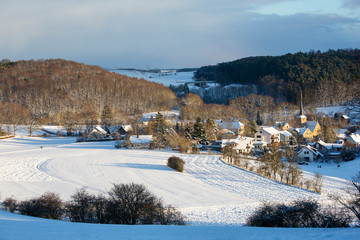 A village in bavaria under a heavy fall of snow on a beautiful winter's day