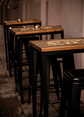 Fototapeta na wymiar Row of rectangular cafe tables on city's sideway