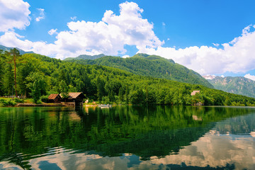 Scenery of wooden houses and boat in Bohinj Lake