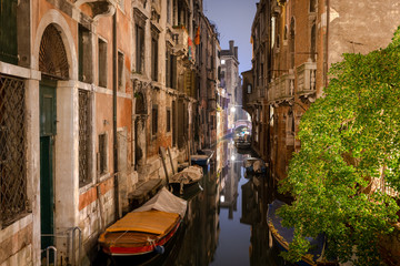 boats docked on a beautiful canal in venice