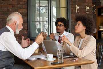 Two representatives of a company meeting with a client.