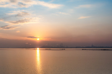 sunset over the venetian lagoon, ,smoke is coming out from some  industrial furnaces