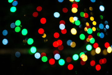 Bright colorful christmas bokeh isolated on black background, Xmas tree light texture, new year holiday decoration