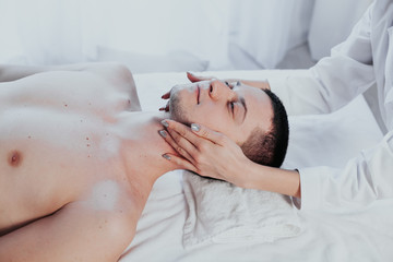 Obraz na płótnie Canvas doctor cosmetologist doing facial massage men spa treatments