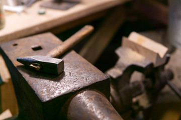 the hammer lies on the anvil in the workshop