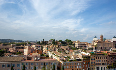 Fototapeta na wymiar Panoramic view of the roofs in Rome and St Peter's Cathedral in the background