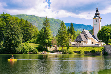 Scenery of man canoeing Bohinj Lake in Slovenia