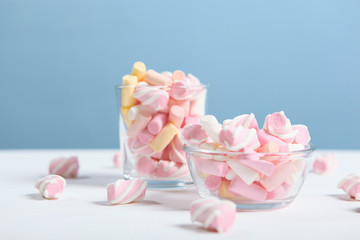 various candy and sweets on the table on a colored background. 