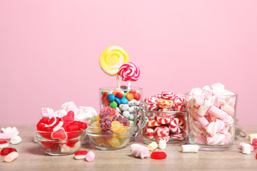 various candy and sweets on the table on a colored background. 