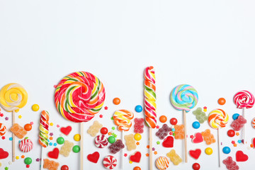 Candies and sweets on a light background, top view with place for text.