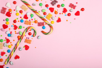 Candies and sweets on a colored background top view with place for text.