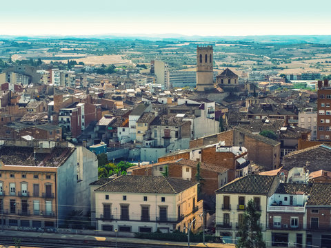 Tarrega, Spain - October 11, 2018: Beautiful urban panorama of the Catalan town of Tarrega - aerial view. Typical Spanish village with tiled roofs and the medieval chapel of Santa Maria de Alba church