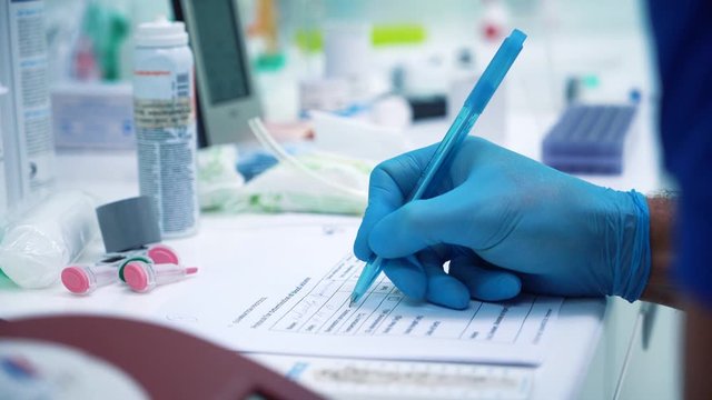 scientist making notes while working in his lab. genetic biohacking research laboratory