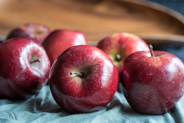 Apples very red and bright, appetizing, on a table