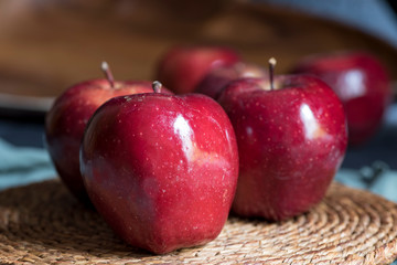Apples very red and bright, appetizing, on a table