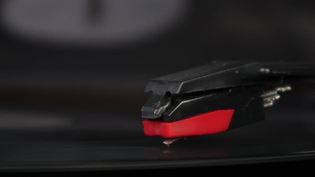 Record needle dropping and playing record on turntable as vinyl record spins bokeh blurry isolated background Nostalgia turntable music