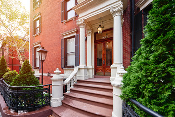 Fototapeta na wymiar A view of a historic brownstone building in an iconic neighborhood of Manhattan, New York City
