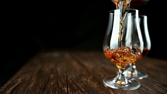 Super slow motion of pouring rum or cognac into glass. Filmed on high speed cinema camera, 1000fps