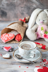 Cookies or gingerbread cookies in a gift box with a red ribbon on a wooden table. Valentine's Day.